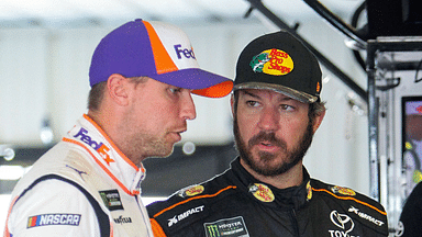 NASCAR Cup Series driver Martin Truex Jr (right) talks with driver Denny Hamlin (left) during practice for the Gander RV 400 at Pocono Raceway.