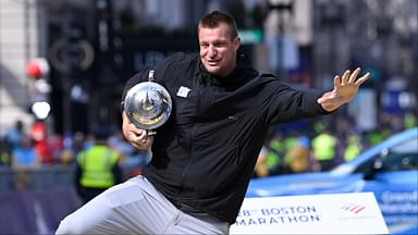 Former New England Patriots tight end and honorary Grand Marshall Rob Gronkowski poses for photos on the finish line of the 2024 Boston Marathon.