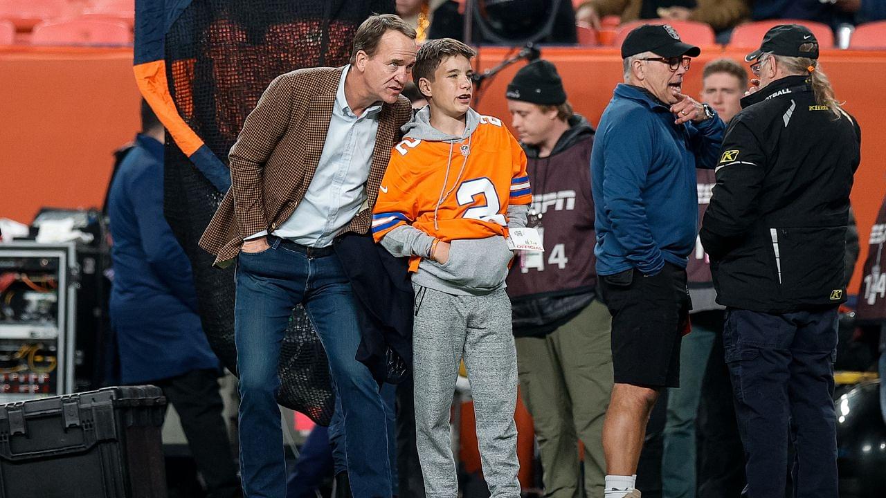 Former Denver Broncos player Peyton Manning with his son Marshall before the game against the Cleveland Browns at Empower Field at Mile High.