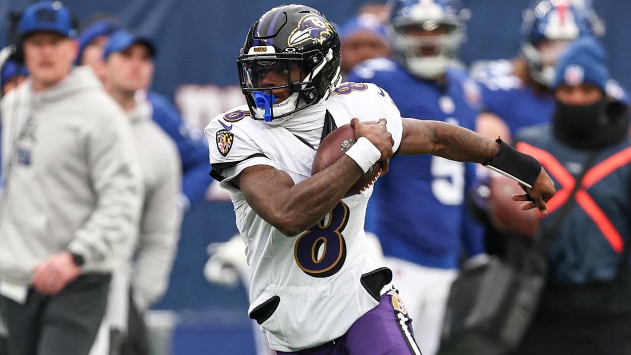 Dec 15, 2024; East Rutherford, New Jersey, USA; Baltimore Ravens quarterback Lamar Jackson (8) carries the ball during the first half against the New York Giants at MetLife Stadium.