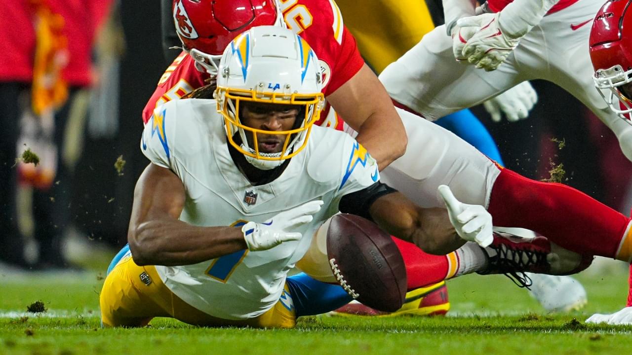 Dec 8, 2024; Kansas City, Missouri, USA; Los Angeles Chargers wide receiver Quentin Johnston (1) recovers a fumble against Kansas City Chiefs defensive end George Karlaftis (56) during the first half at GEHA Field at Arrowhead Stadium.