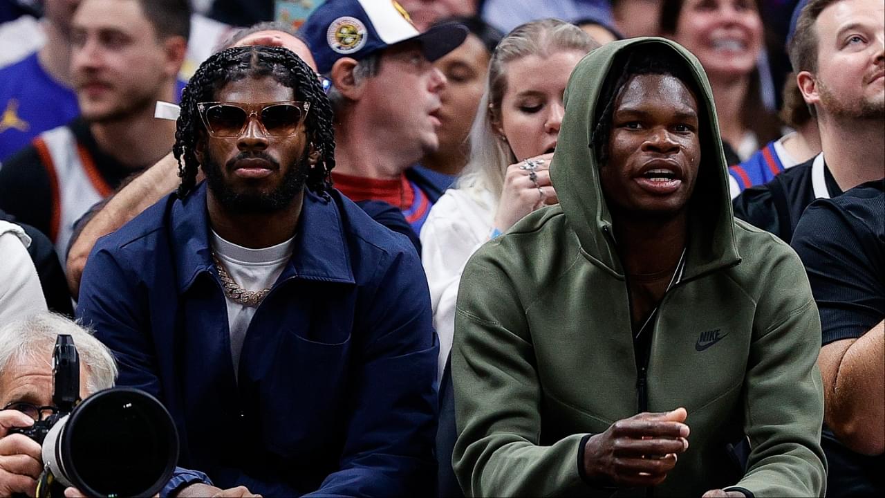 University of Colorado Buffaloes football players Shedeur Sanders (L) and Travis Hunter (R) watch during the third period between the Denver Nuggets and the Los Angeles Lakers at Ball Arena.