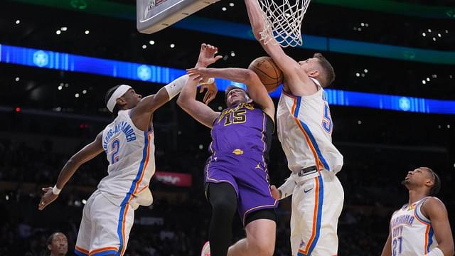 Los Angeles Lakers guard Austin Reaves (15) shoots the ball against Oklahoma City Thunder guard Shai Gilgeous-Alexander (2) and center Isaiah Hartenstein (55) in the first half at Crypto.com Arena.