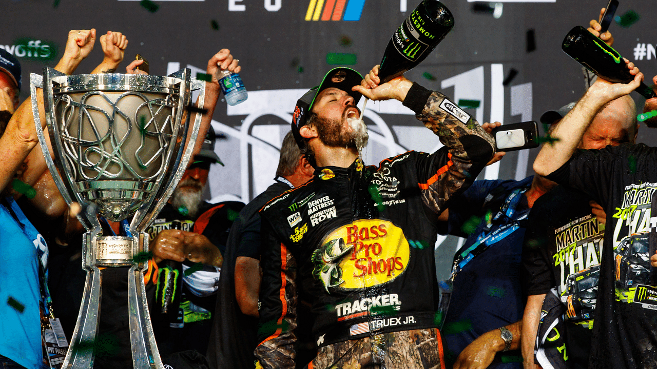 NASCAR Cup Series driver Martin Truex Jr. (78) celebrates with champagne after winning the NASCAR Cup Championship and the Ford EcoBoost 400 at Homestead-Miami Speedway.