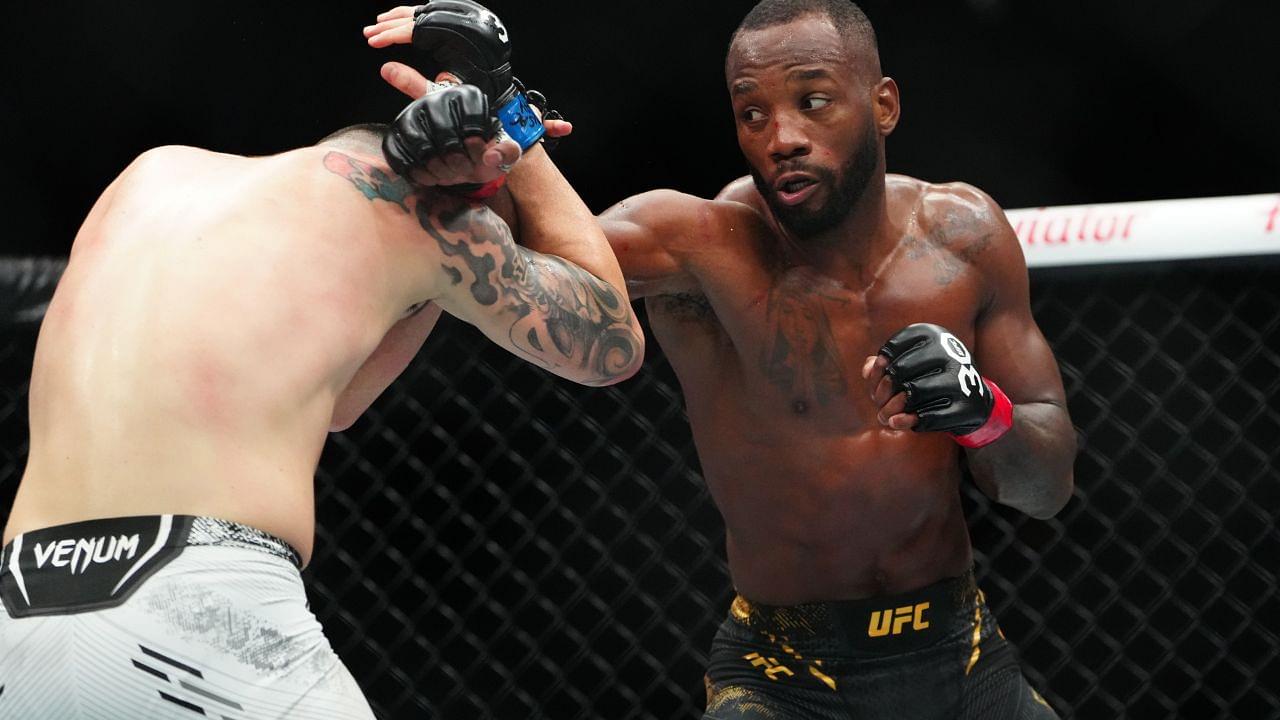 Leon Edwards (red gloves) fights Colby Covington (blue gloves) during UFC 296 at T-Mobile Arena.