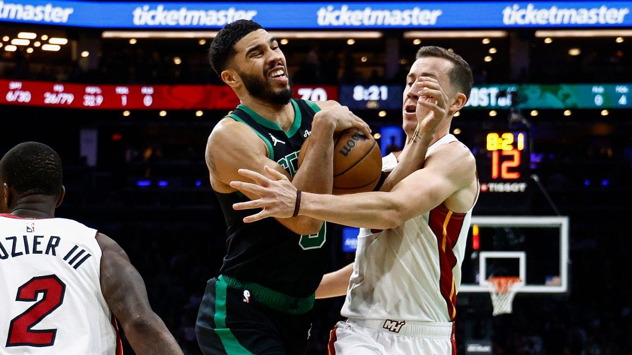 Miami Heat forward Duncan Robinson (55) tries to stop Boston Celtics forward Jayson Tatum (0) from driving to the basket during the second half at TD Garden.