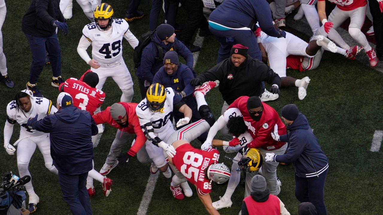 Players scrum at midfield following Saturday’s NCAA Division I football game between the Ohio State Buckeyes and the Michigan Wolverines.