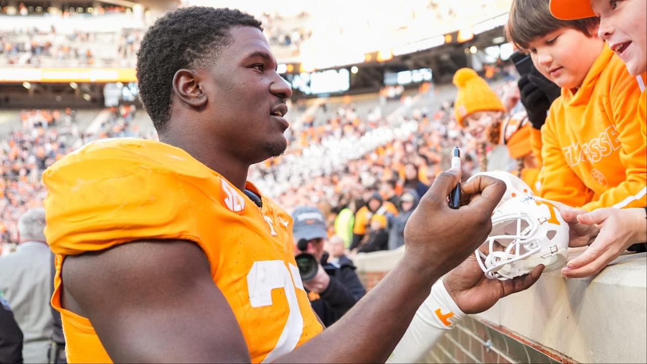 Tennessee defensive lineman James Pearce Jr. (27) autographs items for children after a college football game between Tennessee and UTEP at Neyland Stadium in Knoxville, Tenn., Saturday, Nov. 23, 2024.