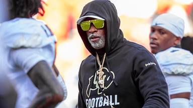 Colorado head coach Deion Sanders watches his players warmup prior to the game between the Kansas Jayhawks and the Colorado Buffaloes at GEHA Field at Arrowhead Stadium.