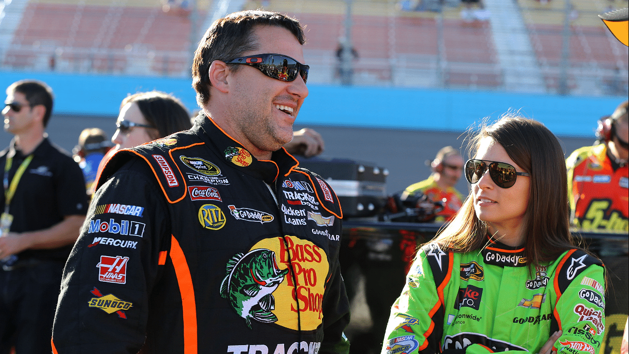 NASCAR Sprint Cup Series driver Tony Stewart (left) talks with teammate Danica Patrick during qualifying for the Subway Fresh Fit 500 at Phoenix International Raceway.