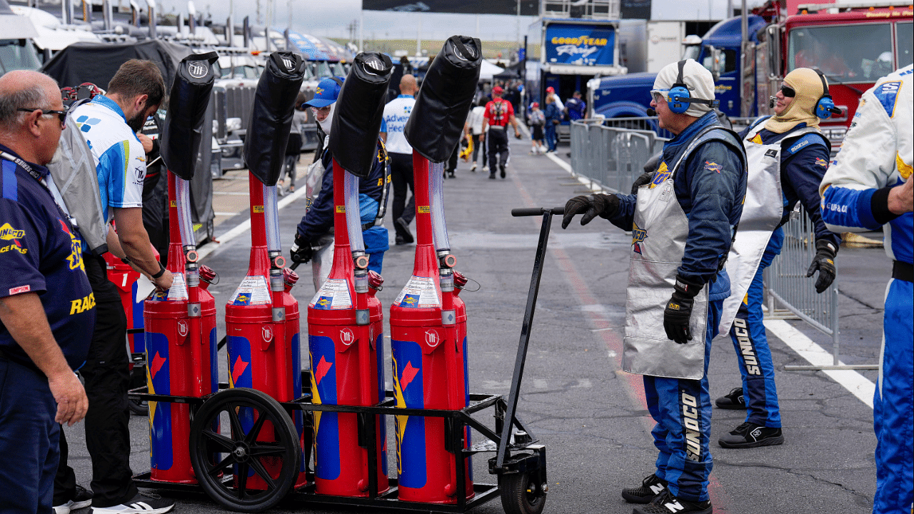 May 29, 2023; Concord, North Carolina, USA; Sunoco fuel crews ready team gas cans before the start during the Coca-Cola 600 at Charlotte Motor Speedway. Mandatory Credit: Jim Dedmon-Imagn Images