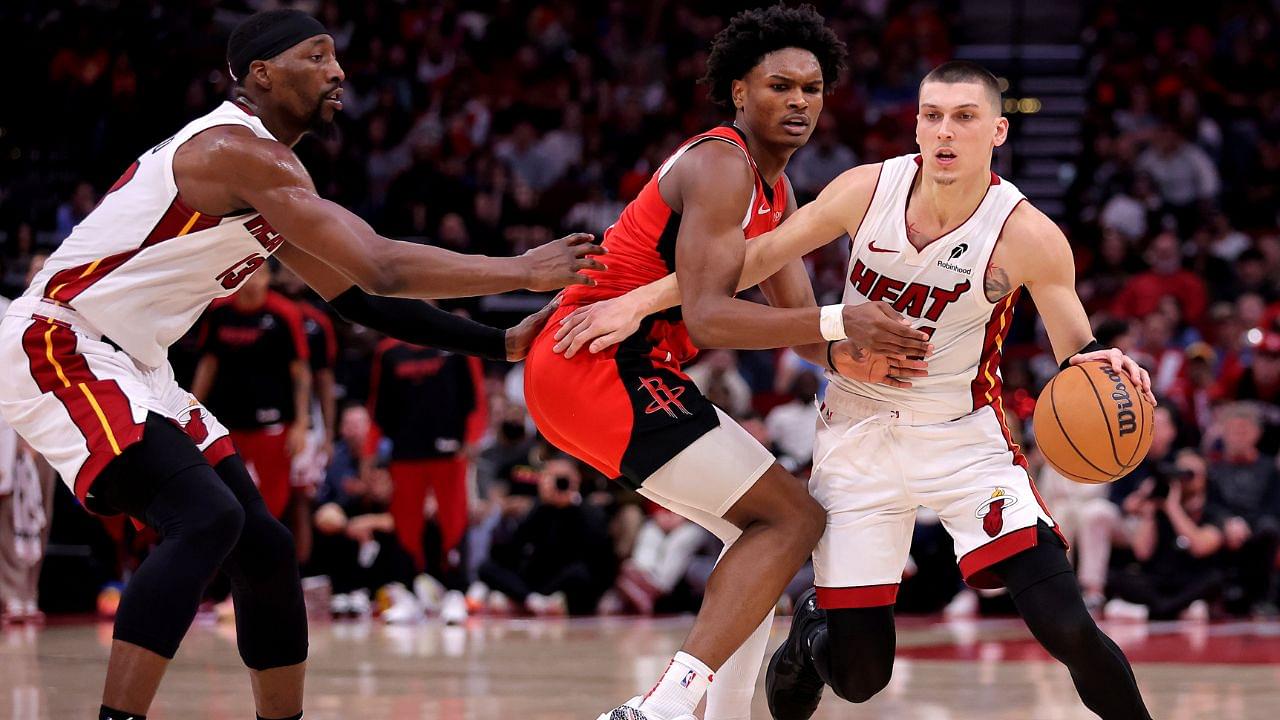 Miami Heat guard Tyler Herro (14) handles the ball against Houston Rockets guard Amen Thompson (1) during the fourth quarter at Toyota Center.