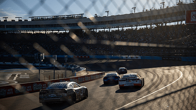 NASCAR Cup Series drivers race into turn three during the NASCAR Cup Series Championship race at Phoenix Raceway.