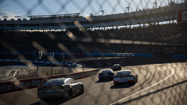 NASCAR Cup Series drivers race into turn three during the NASCAR Cup Series Championship race at Phoenix Raceway.