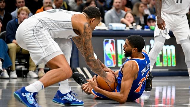 New York Knicks forward Mikal Bridges (25) and Dallas Mavericks forward P.J. Washington (25) battle for control of the ball during the first quarter against the Dallas Mavericks at the American Airlines Center.