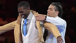 Aug 3, 2018; Canton, OH, USA; Minnesota Vikings, Oakland Raiders, New England Patriots, Tennessee Titans and San Francisco 49ers former receiver Randy Moss receives gold jacket from presenter and son Thaddeus Moss during the Enshrinee's gold jacket dinner at the Canton Civic Center.