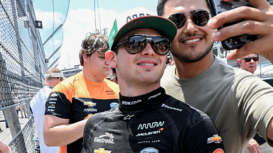 Arrow McLaren driver Pato O'Ward (5) takes a photo with a fan Friday, May 24, 2024, during Carb Day ahead of the 108th running of the Indianapolis 500 at Indianapolis Motor Speedway.