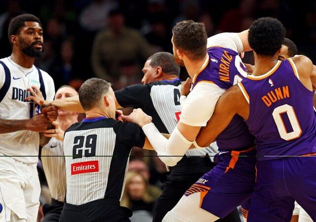 Dallas Mavericks forward Naji Marshall (13) punches Phoenix Suns center Jusuf Nurkic (20) during the third quarter at Footprint Center.