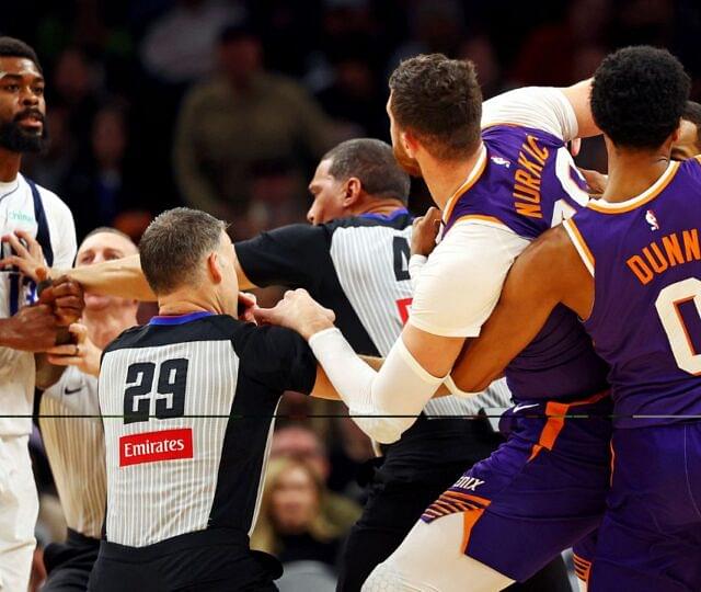 Dallas Mavericks forward Naji Marshall (13) punches Phoenix Suns center Jusuf Nurkic (20) during the third quarter at Footprint Center.