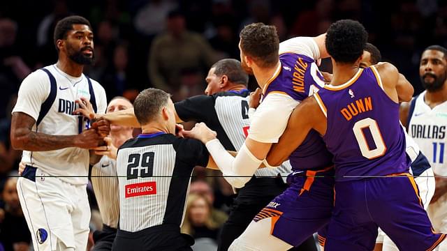 Dallas Mavericks forward Naji Marshall (13) punches Phoenix Suns center Jusuf Nurkic (20) during the third quarter at Footprint Center.