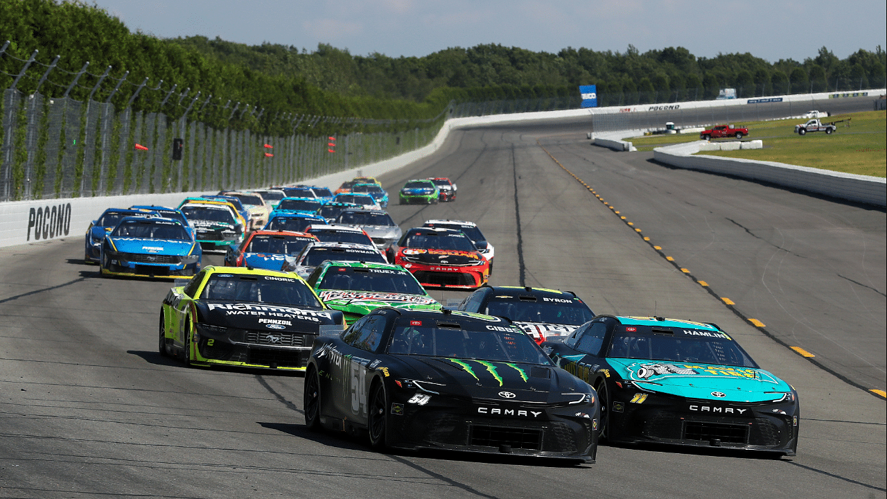 NASCAR Cup Series driver Denny Hamlin (11) races to the inside of driver Ty Gibbs (54) during The Great American Getaway 400 at Pocono Raceway.