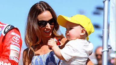 Mar 13, 2016; Avondale, AZ, USA; Samantha Busch , wife of NASCAR Sprint Cup Series driver Kyle Busch (not pictured) holds son Brexton Busch during the Good Sam 500 at Phoenix International Raceway. Mandatory Credit: Mark J. Rebilas-Imagn Images