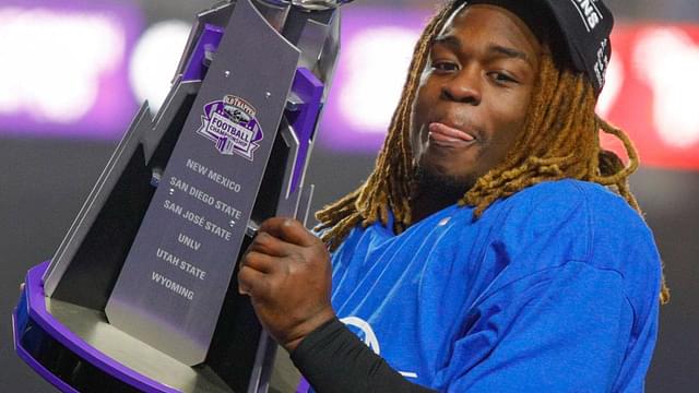 Boise State Broncos running back Ashton Jeanty (2) hoists the Mountain West Trophy after the game against the UNLV Rebels at Albertsons Stadium. Boise State beats UNLV 21-7.