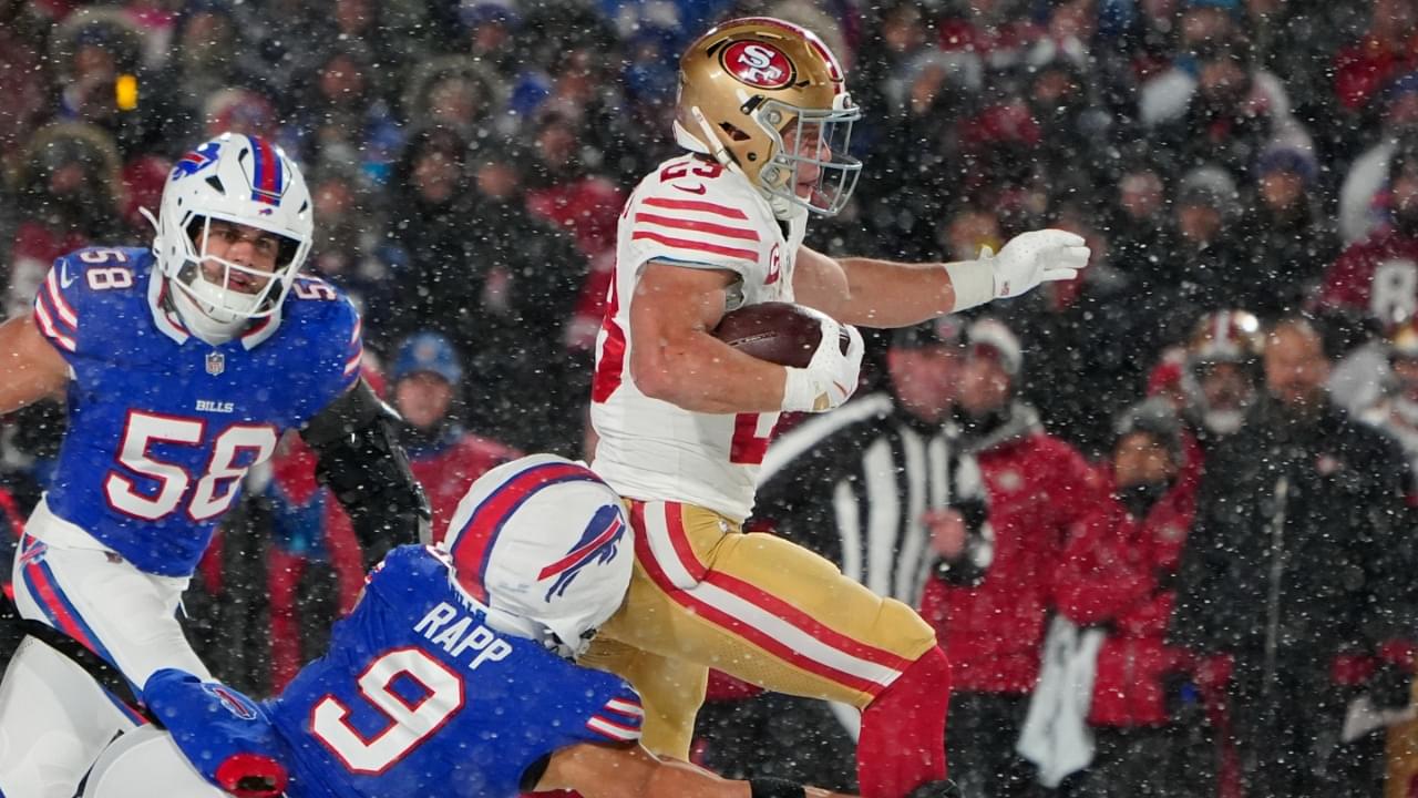 Dec 1, 2024; Orchard Park, New York, USA;San Francisco 49ers running back Christian McCaffrey (23) runs with the ball past Buffalo Bills safety Taylor Rapp (9) during the first half at Highmark Stadium.