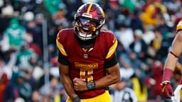 Dec 22, 2024; Landover, Maryland, USA; Washington Commanders quarterback Jayden Daniels (5) celebrates after throwing the game winning touchdown during the fourth quarter against the Philadelphia Eagles at Northwest Stadium.