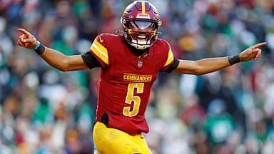 Washington Commanders quarterback Jayden Daniels (5) celebrates after throwing a touchdown during the fourth quarter against the Philadelphia Eagles at Northwest Stadium.