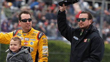 NASCAR Cup Series driver Kyle Busch (left) and driver Kurt Busch (right) wave to the fans prior to the Pocono 400 at Pocono Raceway.