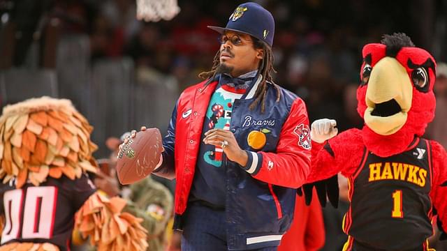 Former NFL quarterback Cam Newton on the court during a game between the Atlanta Hawks and Detroit Pistons in the second quarter at State Farm Arena.