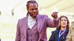 Commentator Richard Sherman signals to fans prior to a game between the Kansas City Chiefs and Las Vegas Raiders at GEHA Field at Arrowhead Stadium.