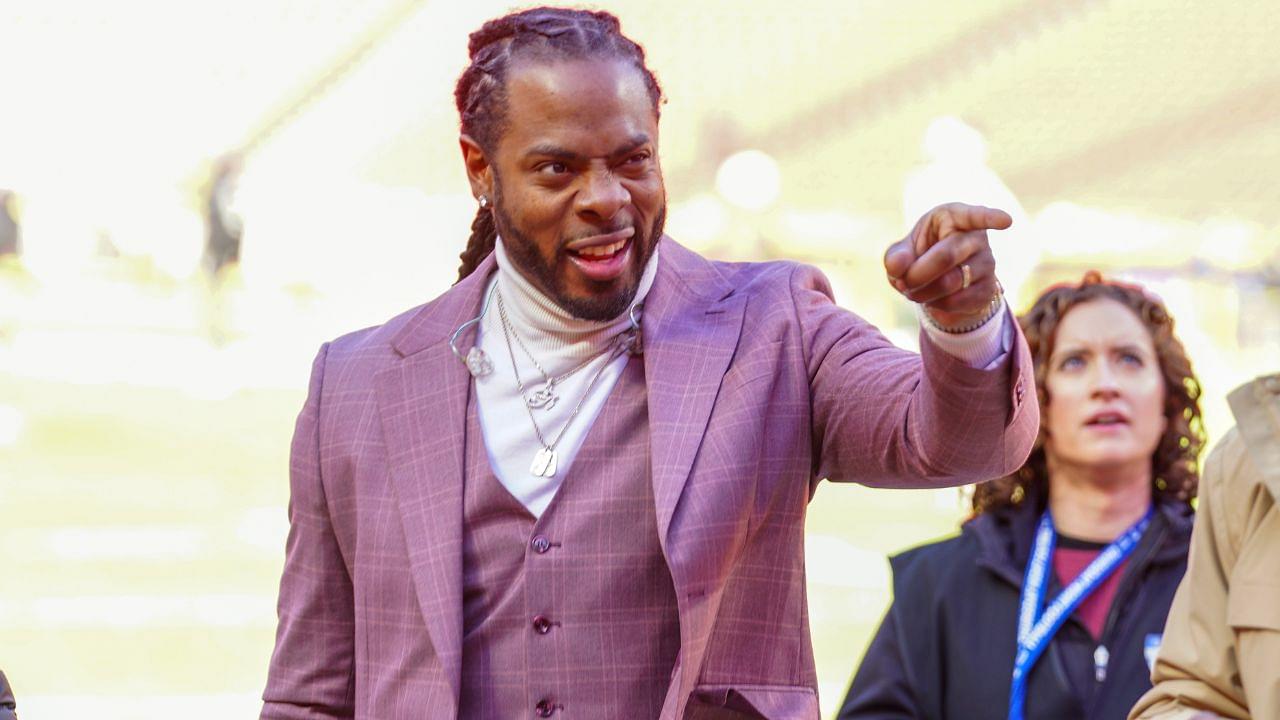 Commentator Richard Sherman signals to fans prior to a game between the Kansas City Chiefs and Las Vegas Raiders at GEHA Field at Arrowhead Stadium.