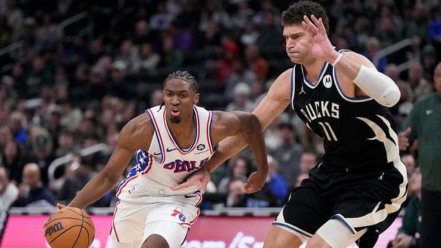 Philadelphia 76ers guard Tyrese Maxey (0) drives to the basket against Milwaukee Bucks center Brook Lopez (11) int he second half at Fiserv Forum