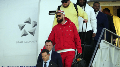 Kansas City Chiefs tight end Travis Kelce exits plane during Super Bowl 58 team arrivals at the Harry Reid International Airport.