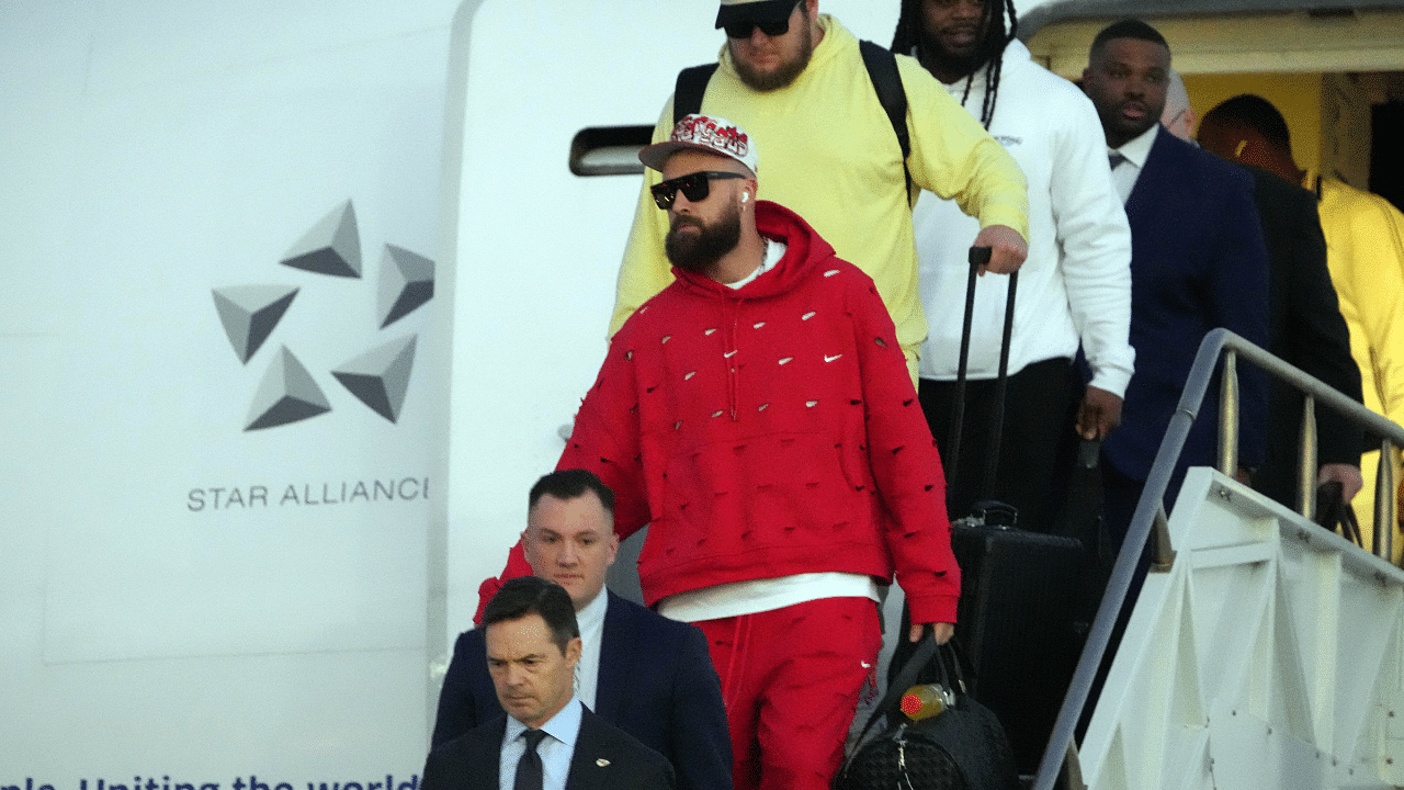 Kansas City Chiefs tight end Travis Kelce exits plane during Super Bowl 58 team arrivals at the Harry Reid International Airport.