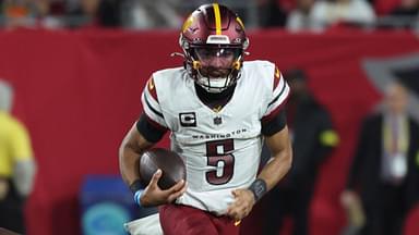 Jan 12, 2025; Tampa, Florida, USA; Washington Commanders quarterback Jayden Daniels (5) scrambles against Tampa Bay Buccaneers defensive tackle Calijah Kancey (94) during the second quarter of a NFC wild card playoff at Raymond James Stadium.