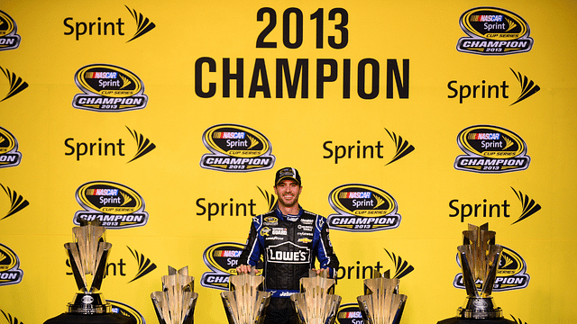 NASCAR Sprint Cup Series driver Jimmie Johnson poses with six Sprint Cup championship trophies after the Ford EcoBoost 400 at Homestead-Miami Speedway.