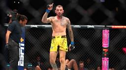 Renato Moicano (blue gloves) reacts after defeating Jalin Turner (red gloves) during UFC 300 at T-Mobile Arena.