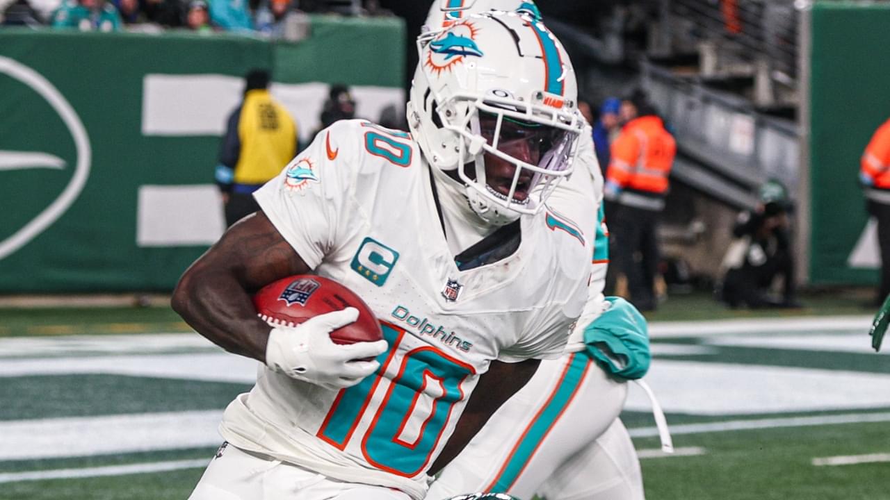 Jan 5, 2025; East Rutherford, New Jersey, USA; Miami Dolphins wide receiver Tyreek Hill (10) is tackled by New York Jets running back Isaiah Davis (32) during a punt return during the first half at MetLife Stadium.