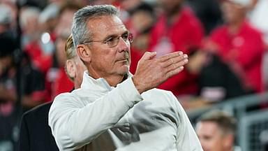 Former Ohio State Buckeyes head coach Urban Meyer salutes the fans chanting his name during the College Football Playoff quarterfinal against the Oregon Ducks at the Rose Bowl in Pasadena, Calif.