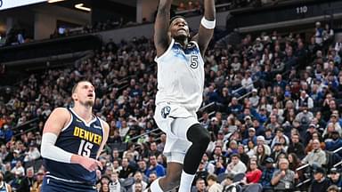 Minnesota Timberwolves guard Anthony Edwards (5) goes to the basket for a slam dunk over Denver Nuggets center Nikola Jokic (15) during the third quarter at Target Center.