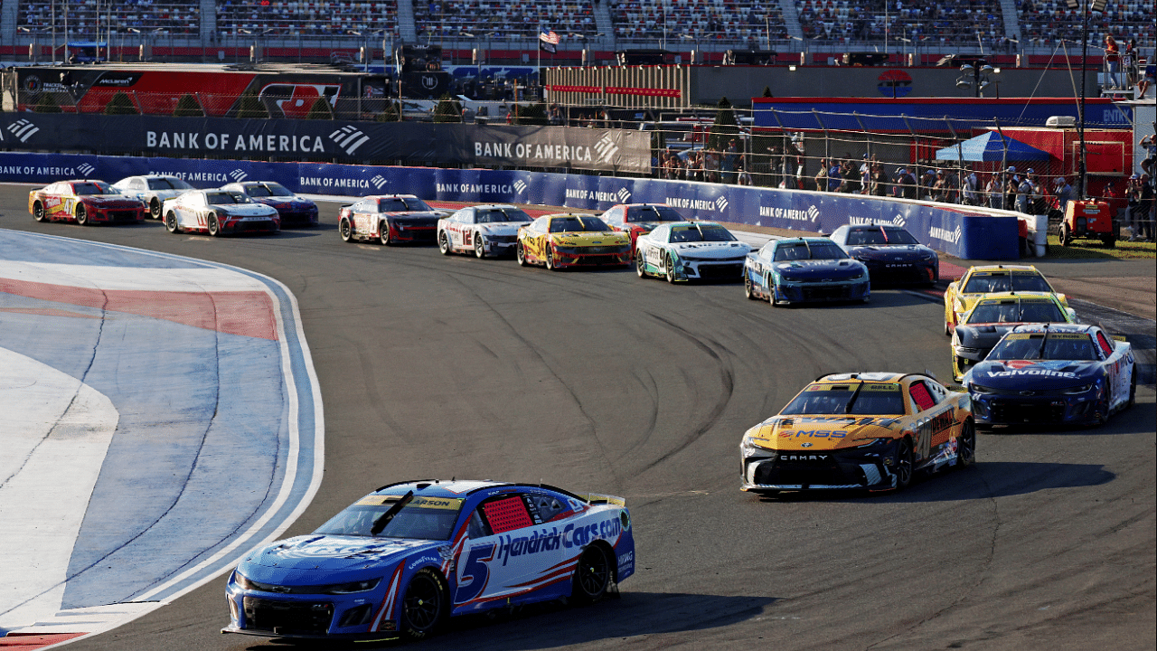 Oct 13, 2024; Concord, North Carolina, USA; NASCAR Cup Series driver Kyle Larson (5) leads the field into turn 4 during the Bank of America ROVAL 400 at Charlotte Motor Speedway Road Course. Mandatory Credit: Peter Casey-Imagn Images