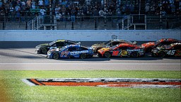 Sep 29, 2024; Kansas City, Kansas, USA; NASCAR Cup Series driver Corey LaJoie (51) and driver Carson Hocevar (77) lead at the start of the third stage during the Hollywood Casino 400 at Kansas Speedway. Mandatory Credit: Amy Kontras-Imagn Images