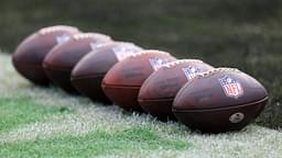 Balls are lined up before an NFL football matchup Sunday, Dec. 29, 2024 at EverBank Stadium in Jacksonville, Fla.