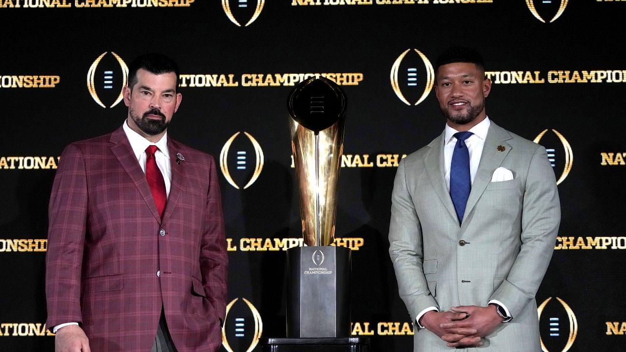 Ohio State Buckeyes head coach Ryan Day (left) and Notre Dame Fighting Irish head coach Marcus Freeman pose with the College Football Playoff National Championship trophy at press conference at The Westin Peachtree Plaza, Savannah Ballroom.