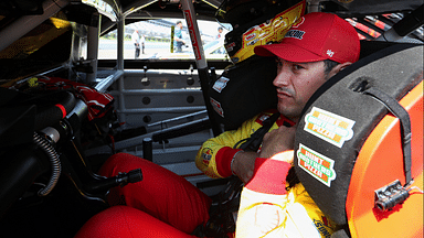 Jul 13, 2024; Long Pond, Pennsylvania, USA; NASCAR Cup Series driver Joey Logano sits in his car on pit road during practice and qualifying for the The Great American Getaway 400 at Pocono Raceway. Mandatory Credit: Matthew O'Haren-Imagn Images