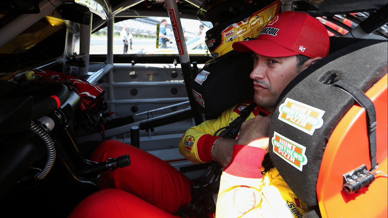 Jul 13, 2024; Long Pond, Pennsylvania, USA; NASCAR Cup Series driver Joey Logano sits in his car on pit road during practice and qualifying for the The Great American Getaway 400 at Pocono Raceway. Mandatory Credit: Matthew O'Haren-Imagn Images