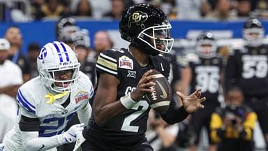 Dec 28, 2024; San Antonio, TX, USA; Colorado Buffaloes quarterback Shedeur Sanders (2) runs with the ball as Brigham Young Cougars cornerback Evan Johnson (21) attempts to make a tackle during the third quarter at Alamodome.